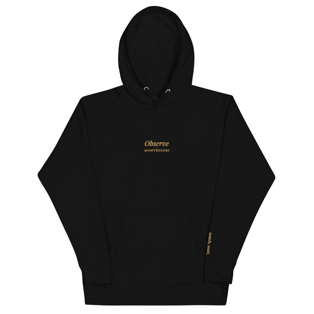 Observe Embroidered Hoodie in Black, front flat view.