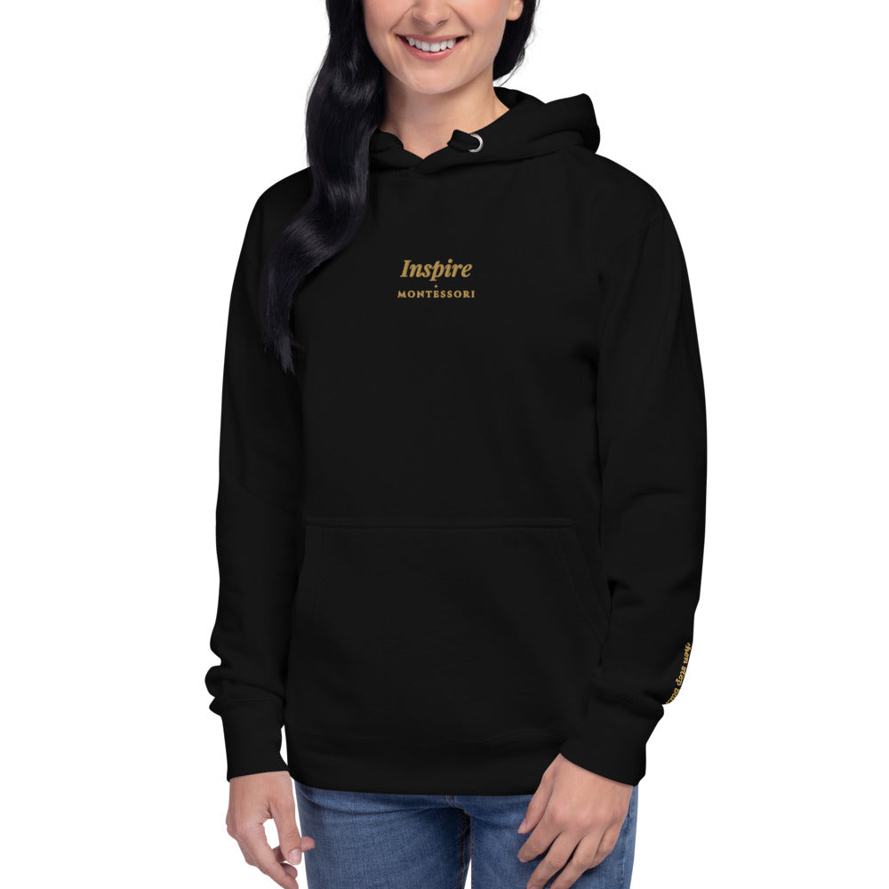 Inspire Embroidered Hoodie in Black, front view, worn.