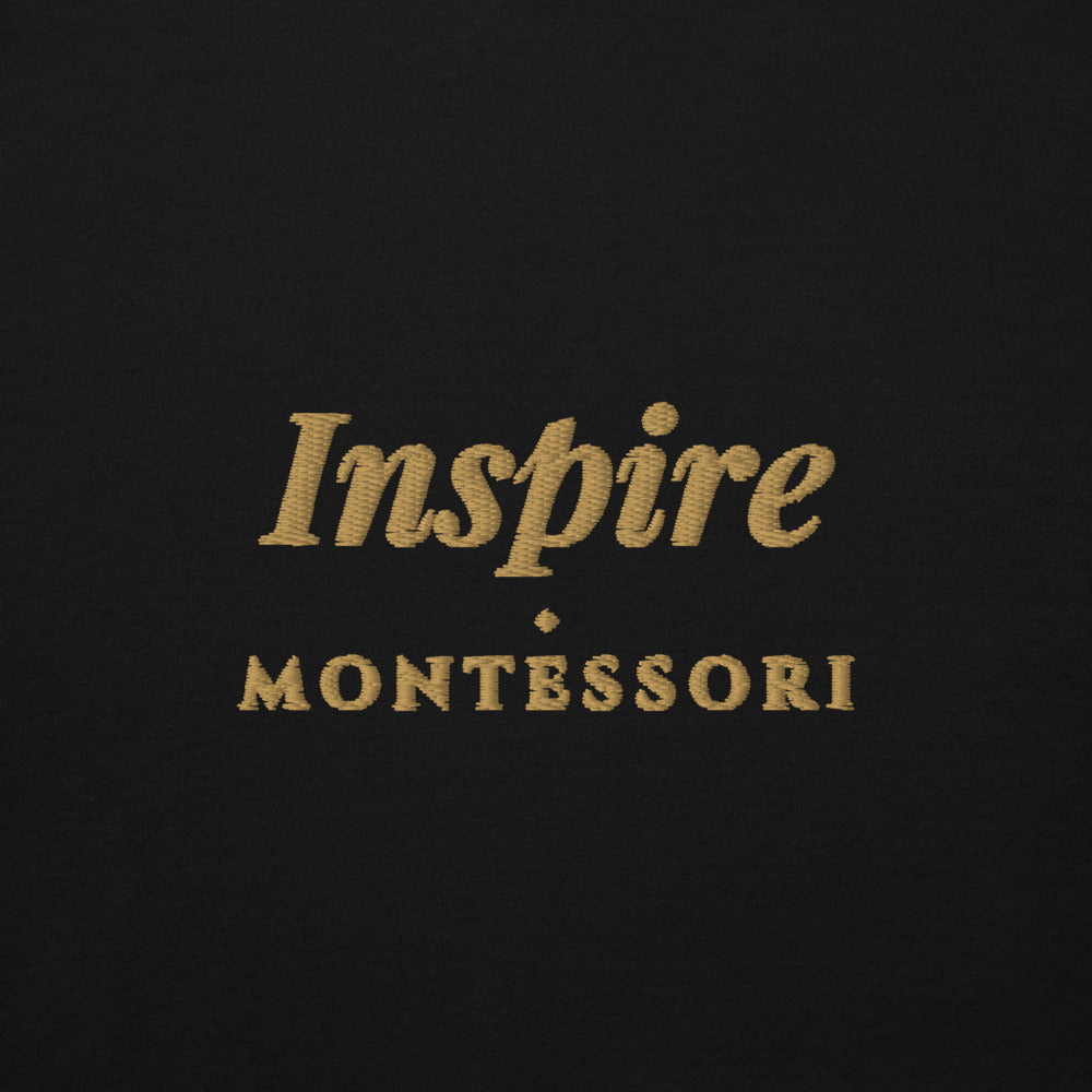 Inspire Embroidered Hoodie in Black, front view, worn.